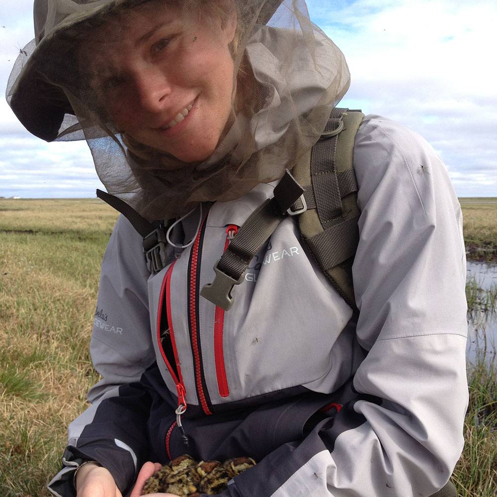 Amanda smiles from beneath her mosquito net.